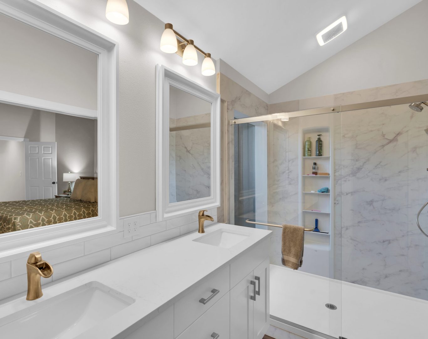 Elegant white bathroom with glass shower and stylish patterned floor.